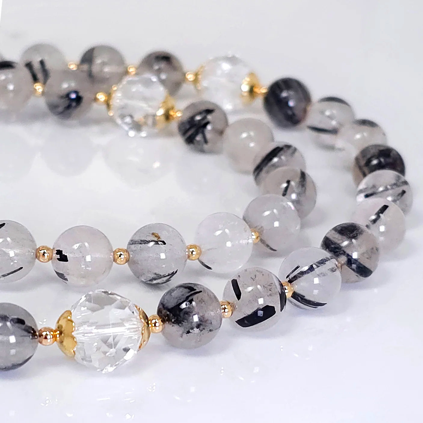 Handcrafted necklace rosary emphasizing the lustrous Black Tourmaline Quartz gemstones with Gold-plated Crucifix pendant.