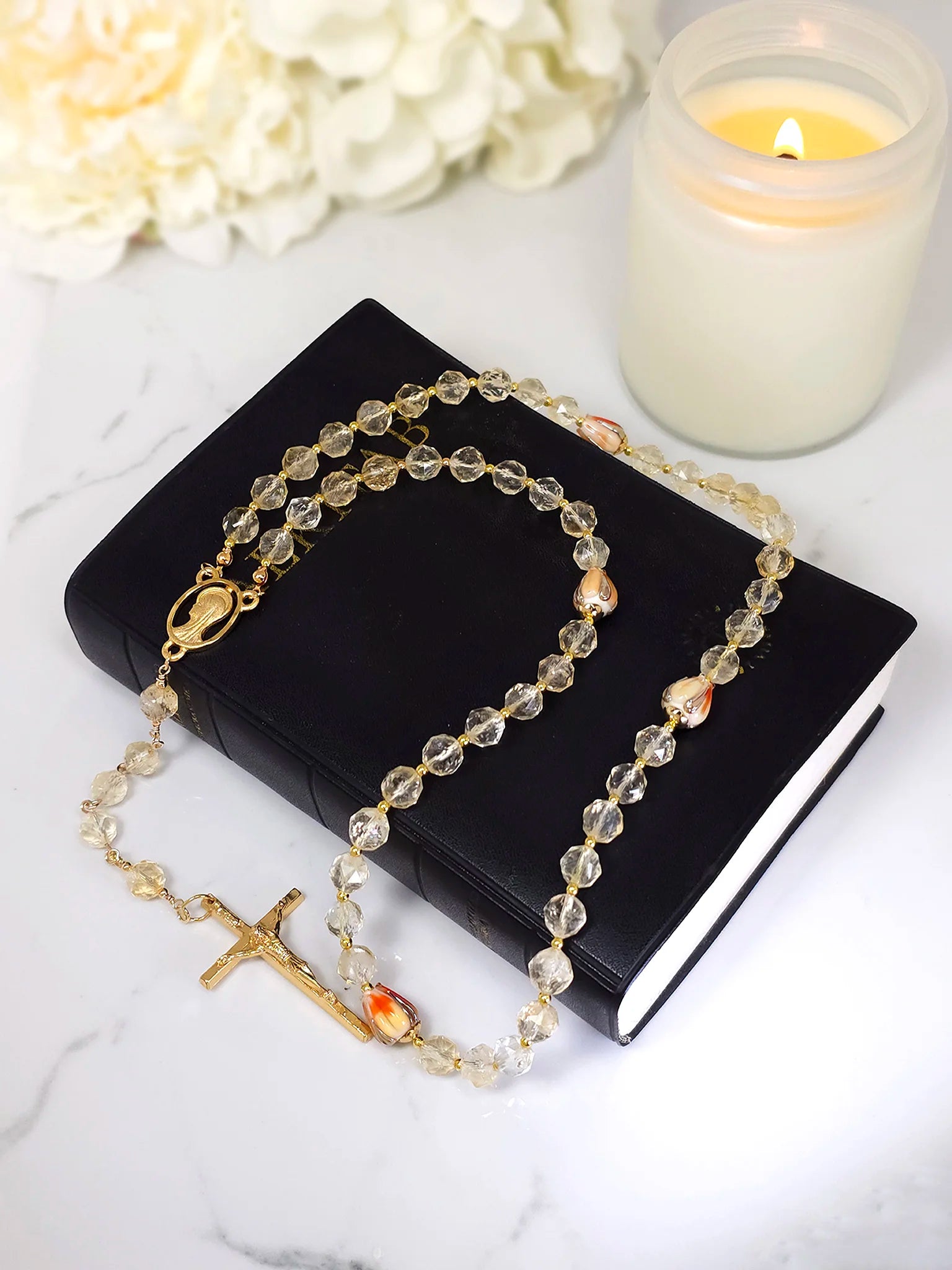 Rosary with gold citrine beads and orange glass flower accents, complemented by a gold-plated Crucifix pendant.