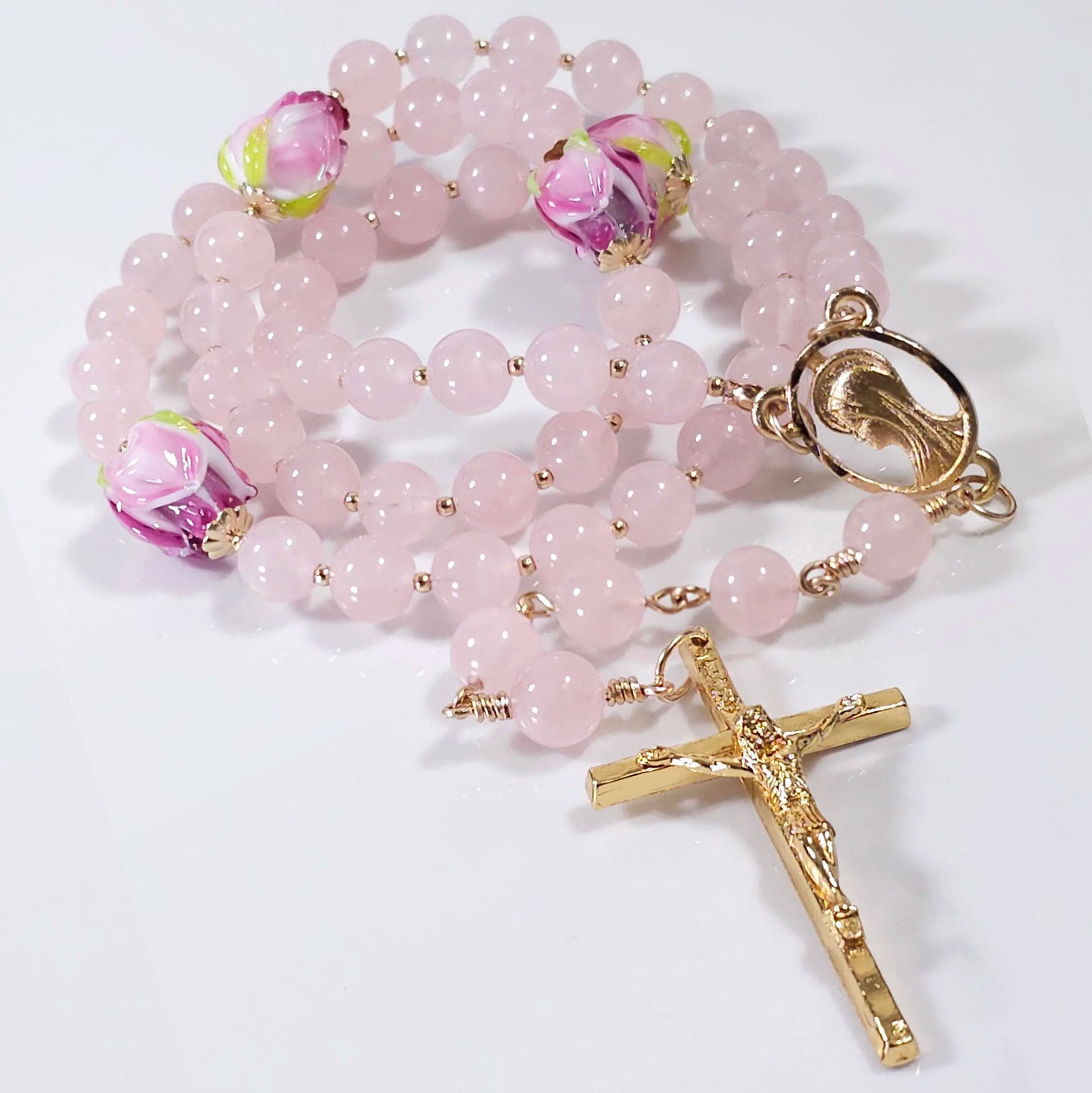 Mystical rose rosary made from rose quartz gemstone, Italian glass flower beads, gold cross and Madonna medal.