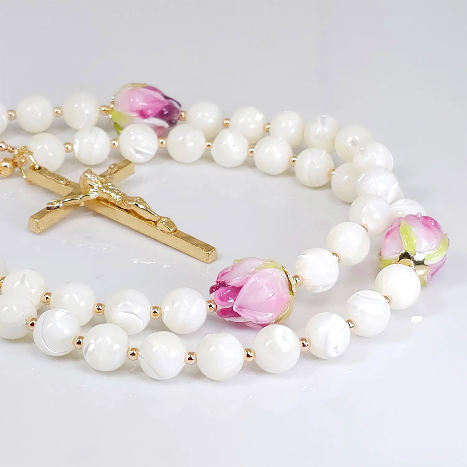 Elegant rosary highlighting Mother of Pearl beads, complemented by pink rosebud flower glass beads.