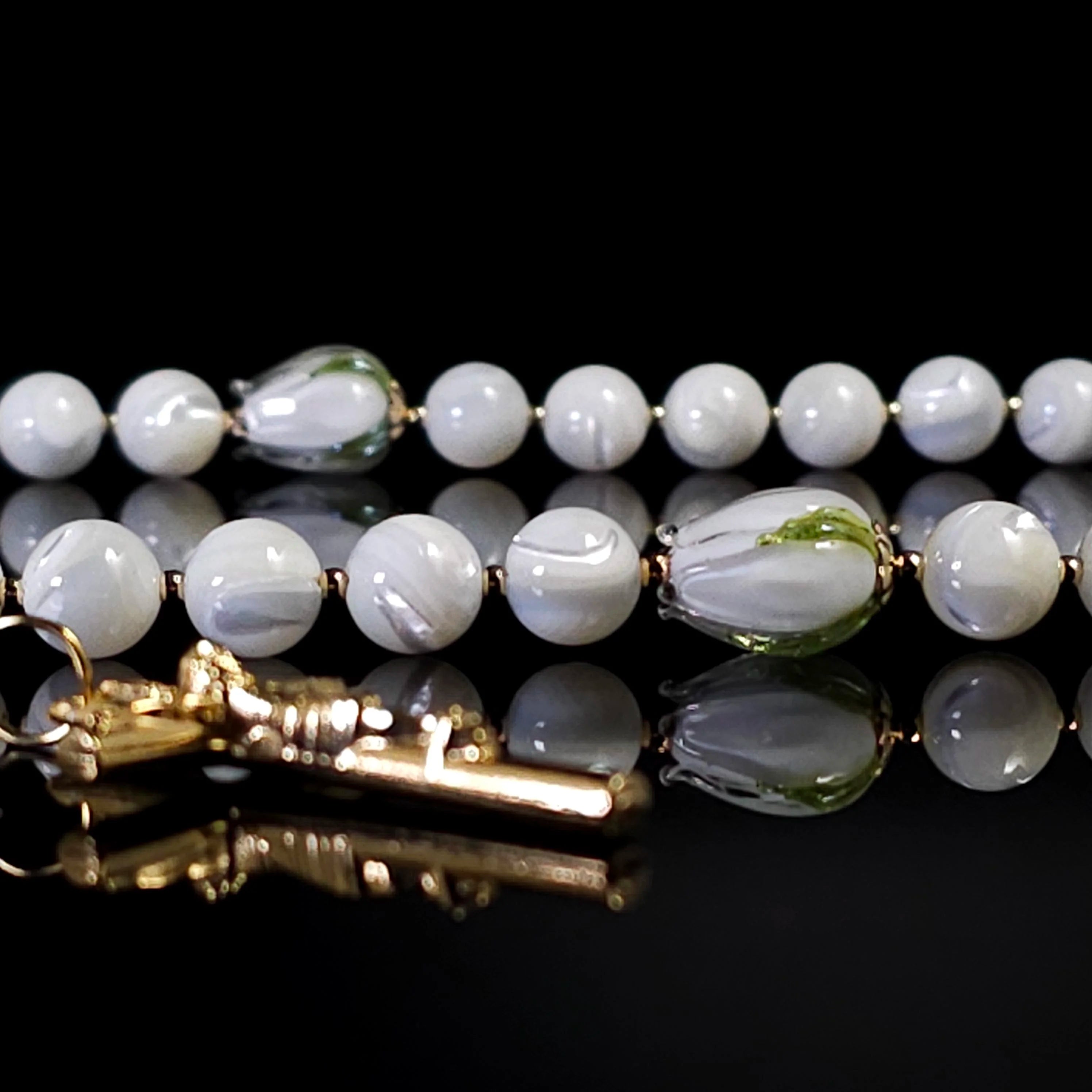 White mother of pearl rosary adorned with white tulip glass beads.