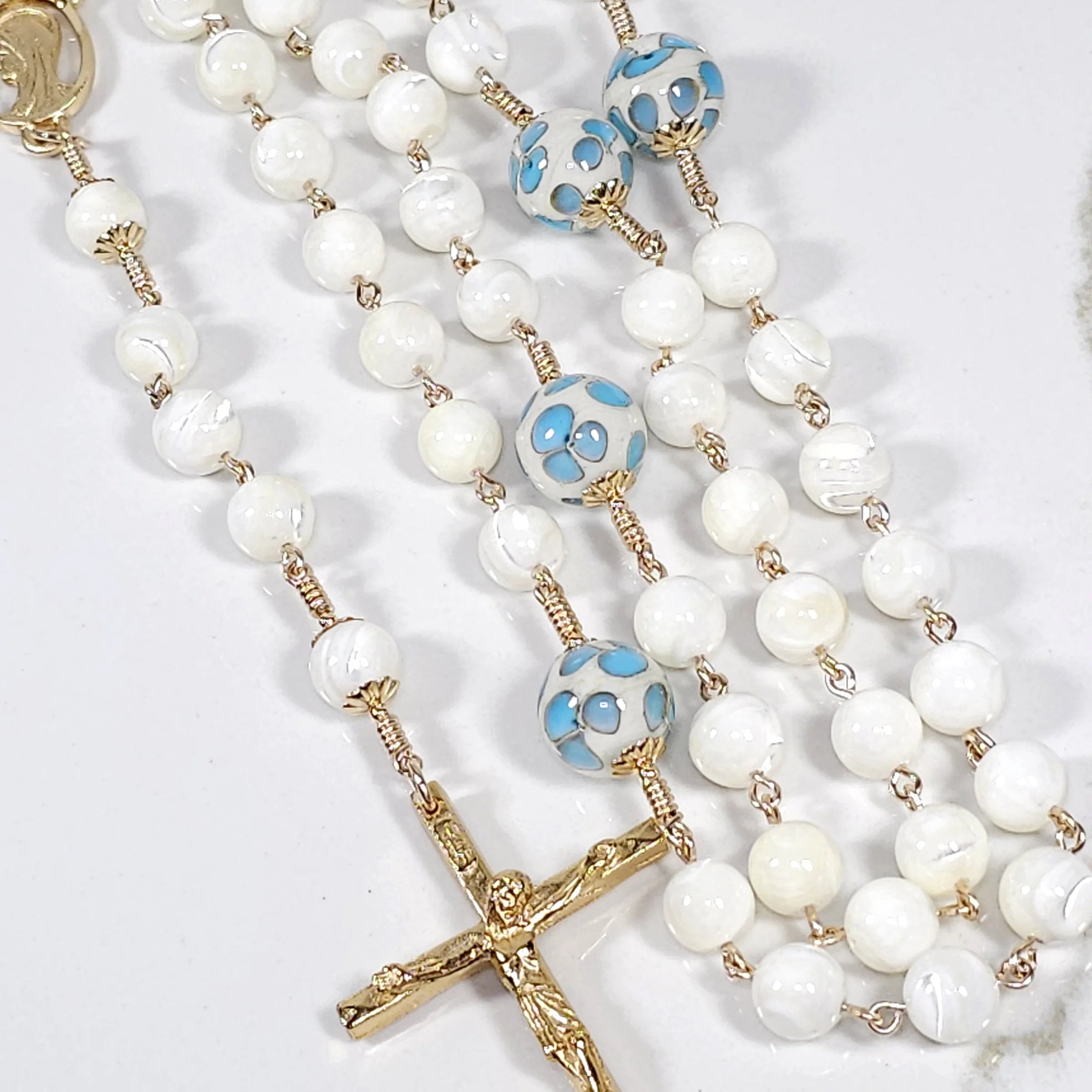 beautiful little blue flower and white pearl rosary perfect for our lady of Lourdes devotion.