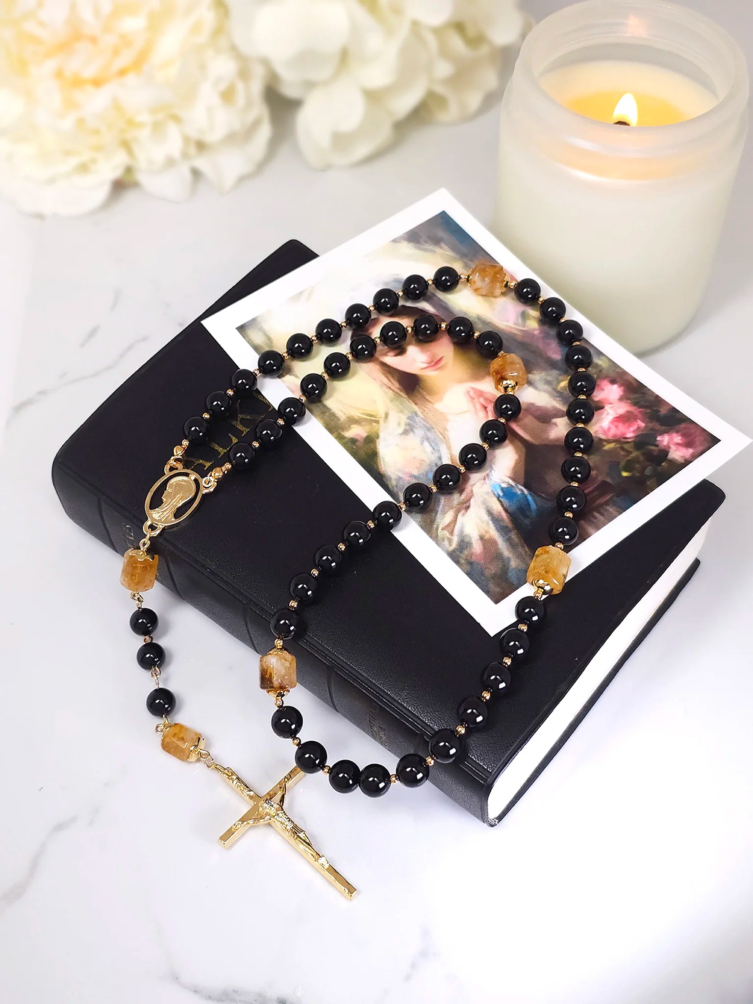rosary lay on top of catholic bible.