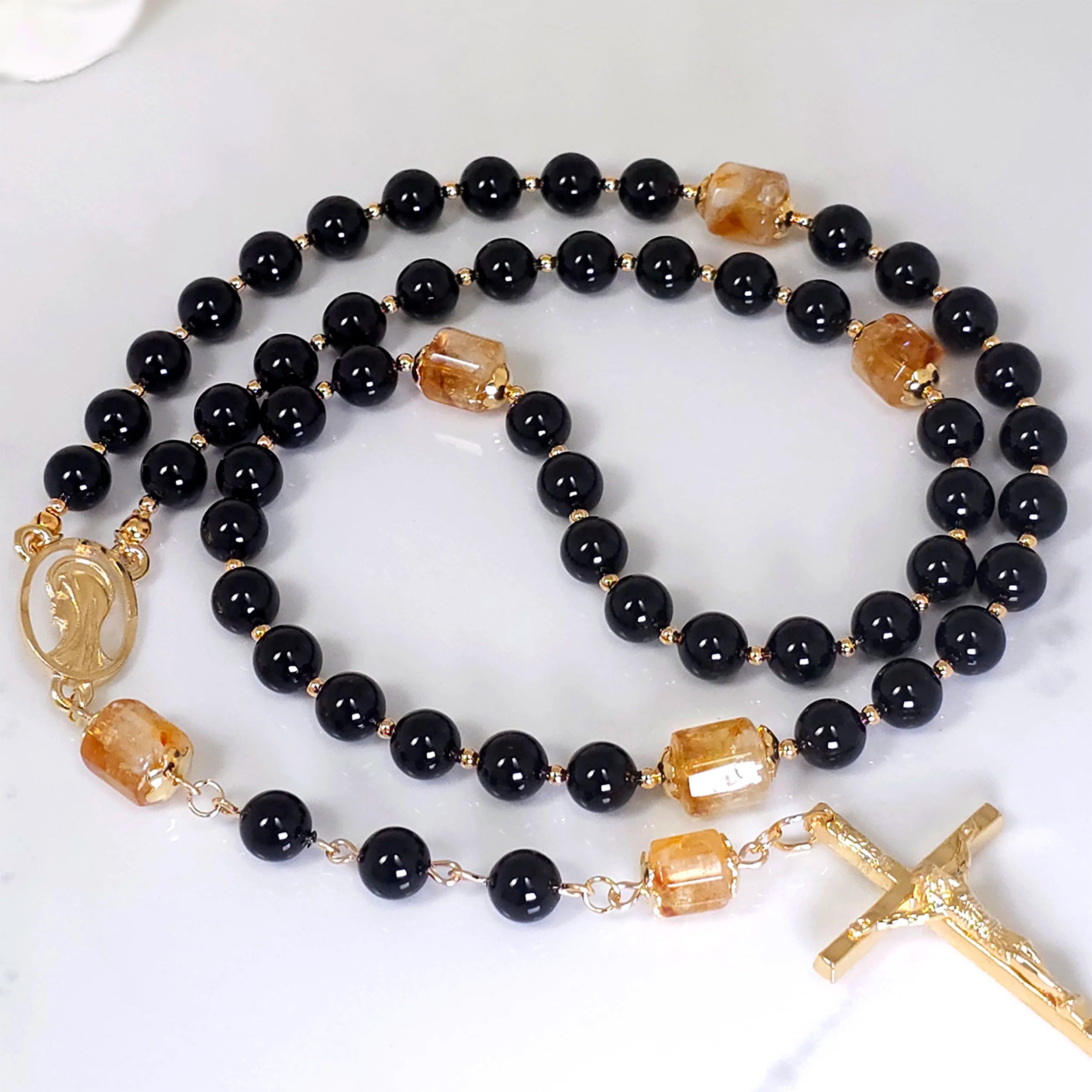Black rosary laying on the table.
