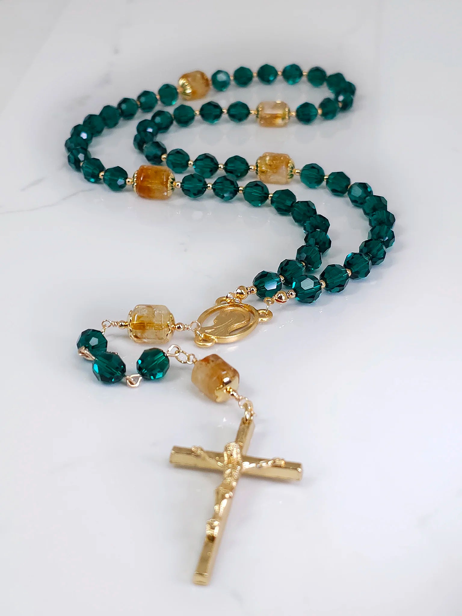 Birthstone-inspired rosary emphasizing the significance of emerald, displayed against a white background.