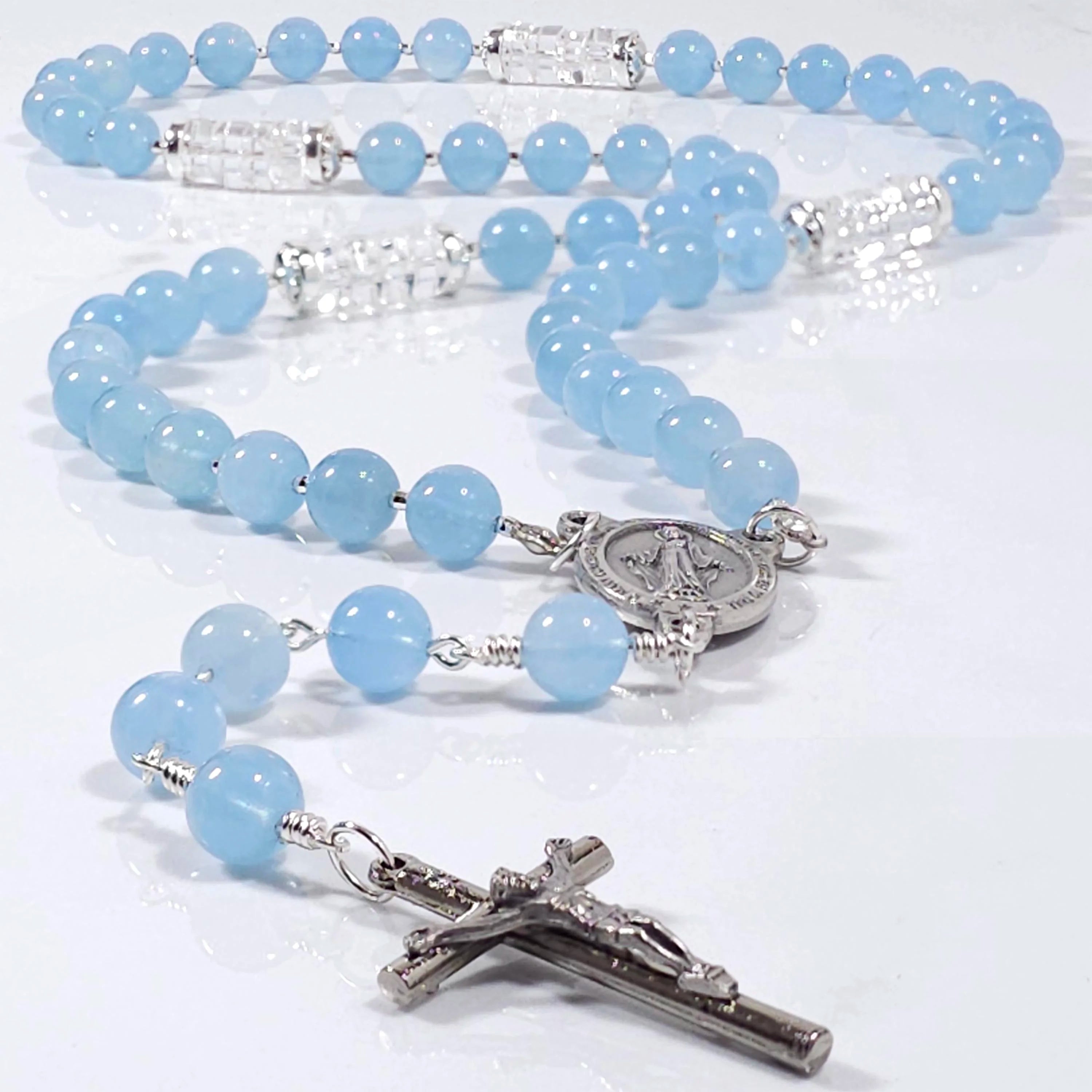 Marian blue salve Regina rosary on top of a table.