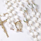 white and gold rosary with mother of pearl.