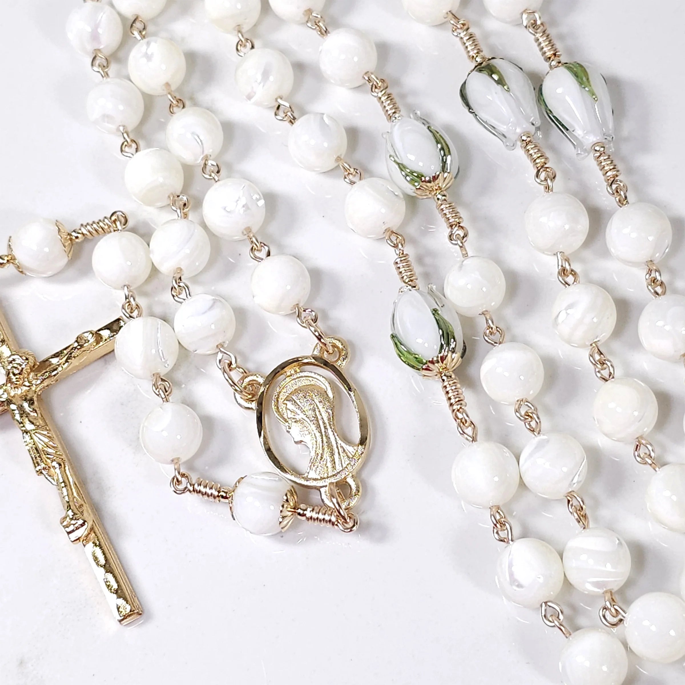 white and gold rosary with mother of pearl.