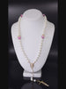 Classic necklace rosary emphasizing Mother of Pearl beads, complemented by pink rosebud beads.