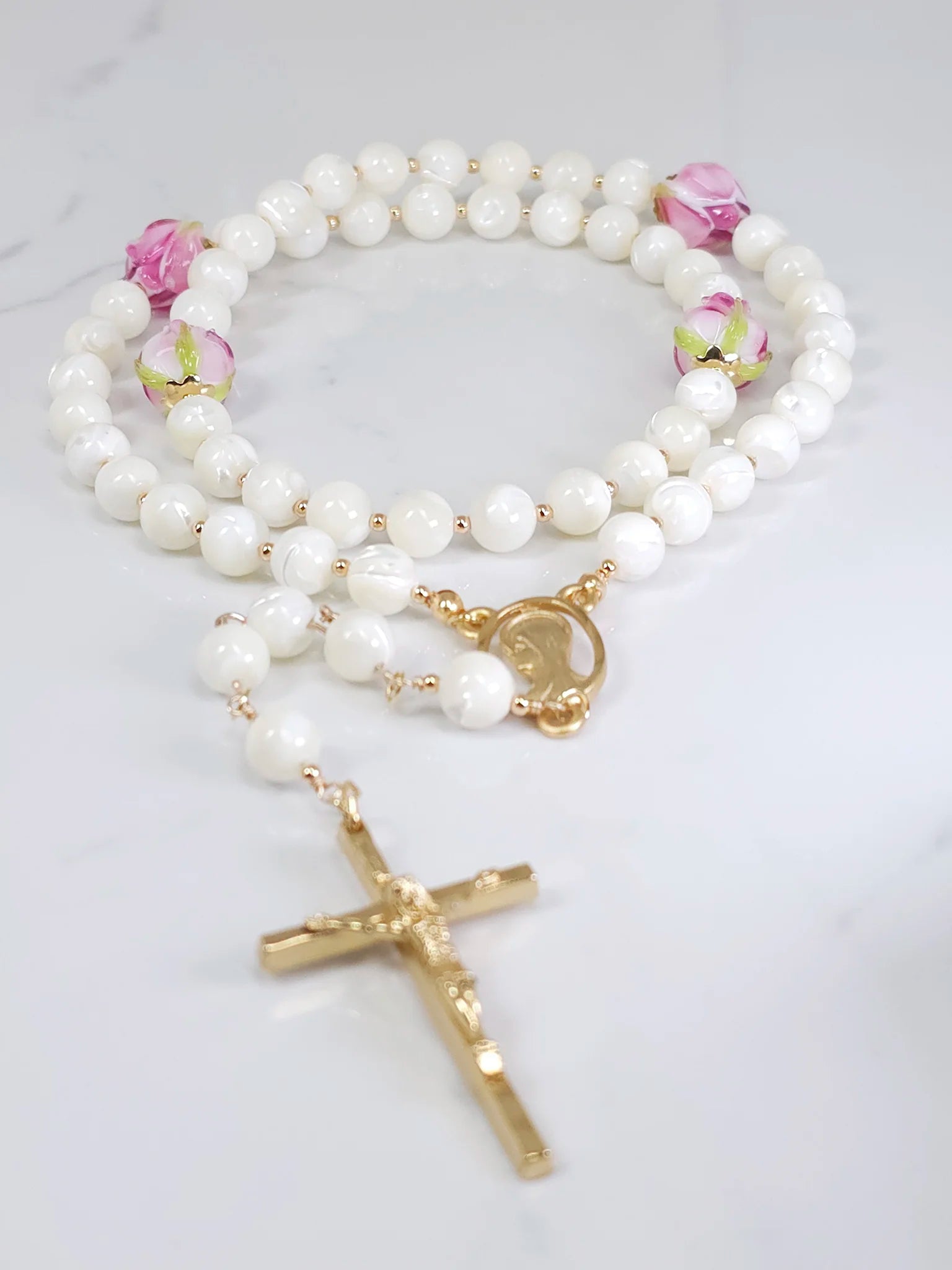Bridal rosary emphasizing Mother of Pearl and pink rosebud flower beads.