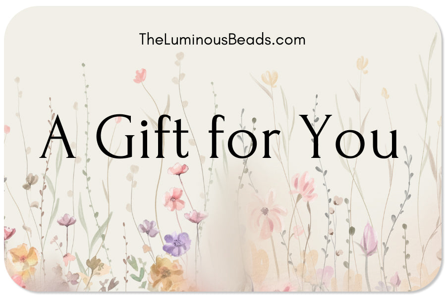 The Luminous Beads Gift card  with soft color flowery design and the Luminous Beads name.